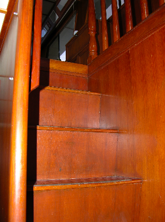 Polished wood steps and handrails lead below.