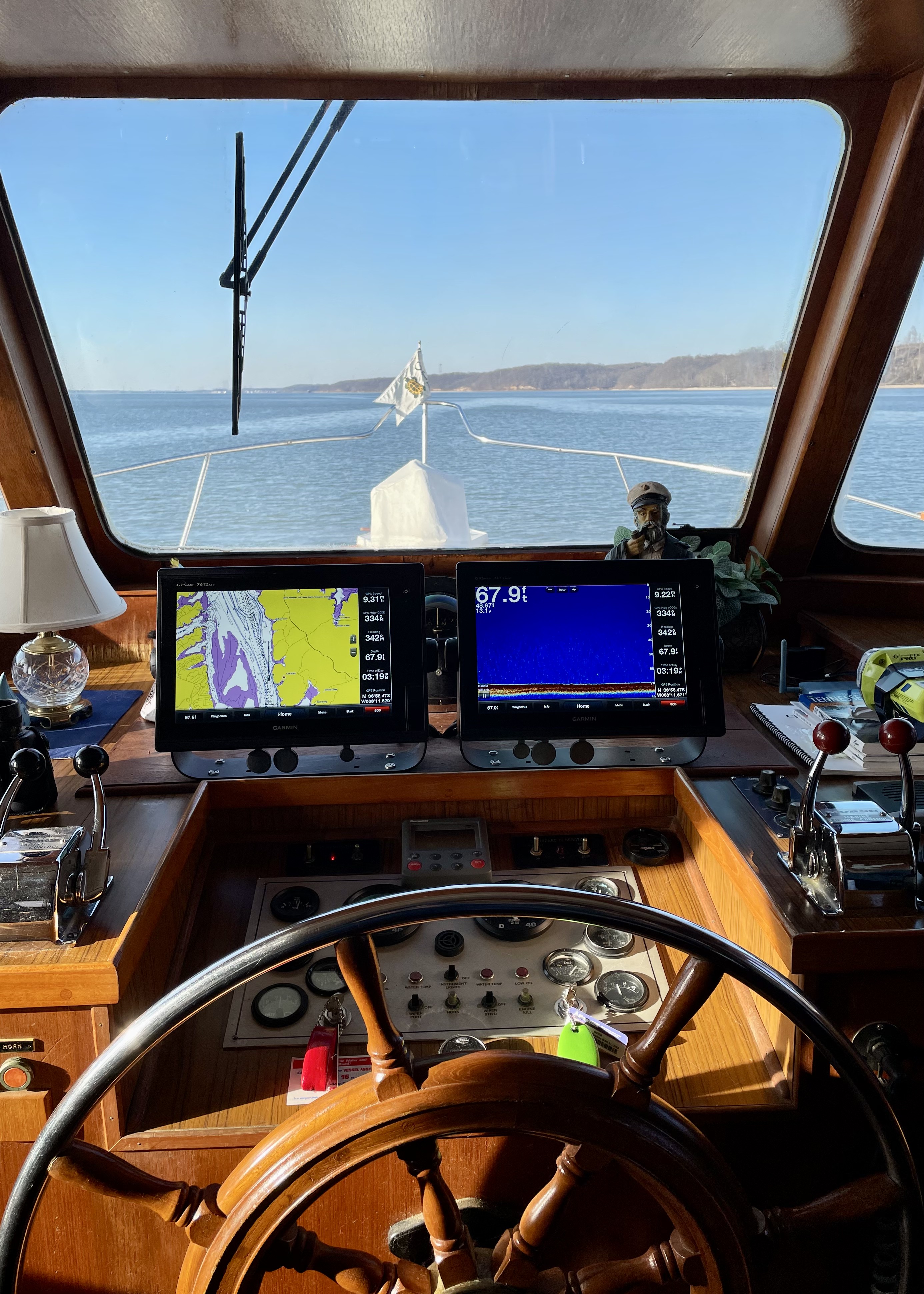 The pilothouse helm frames a clear view ahead.