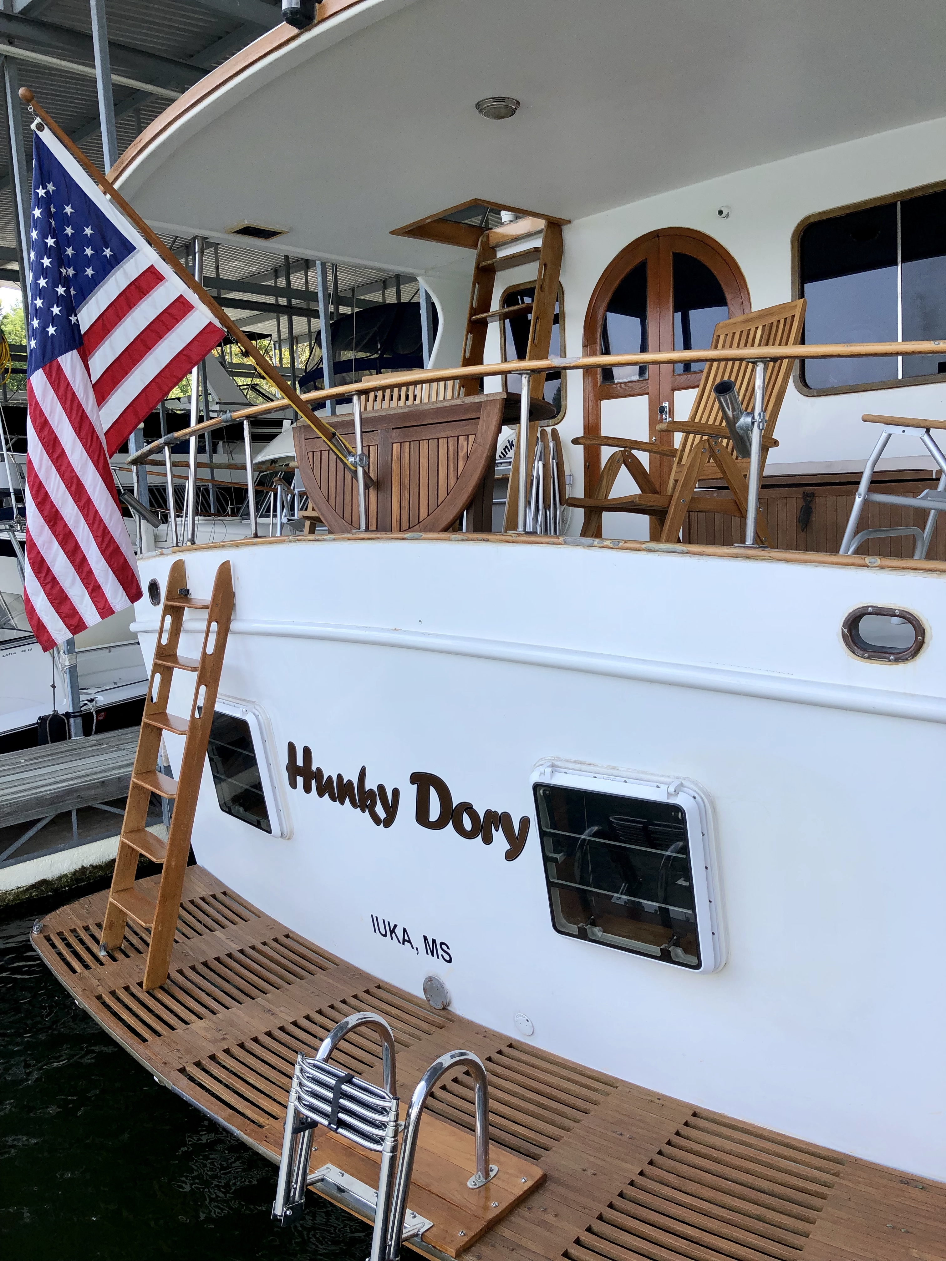 The aft deck, nameboard, and teak swim platform.